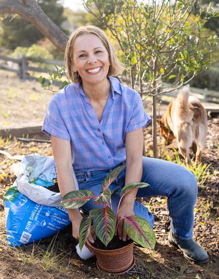 Carinne Hawley, wellness coach, working in her garden