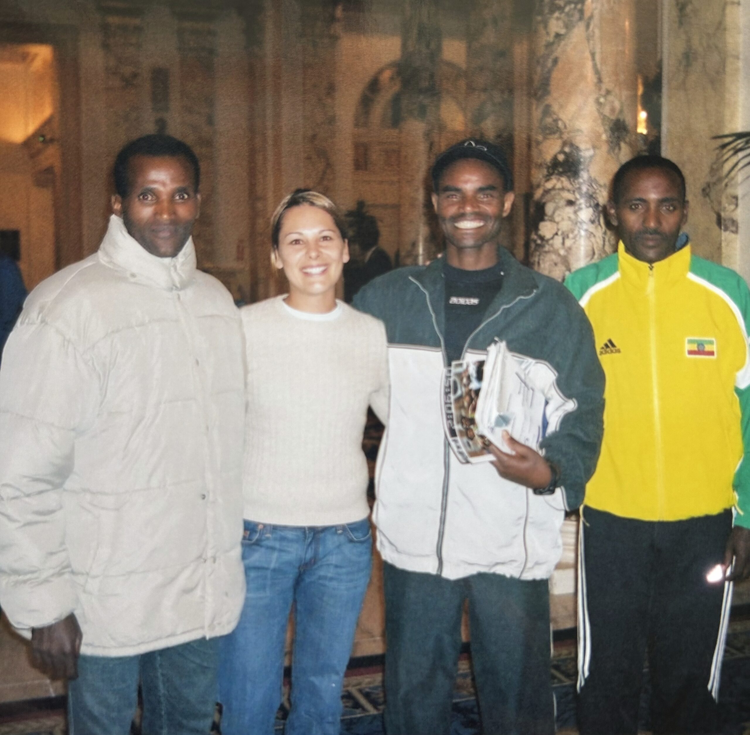 Carinne posing with Ethiopian runner, Belayneh Dinsamo at the Boston Marathon.