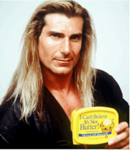 The model Fabio holding a tub of I Can't Believe It's not Butter